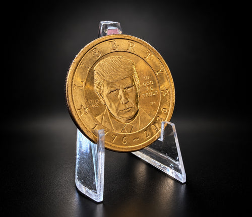 Donald Trump dollar with July 4th privy on a clear display stand